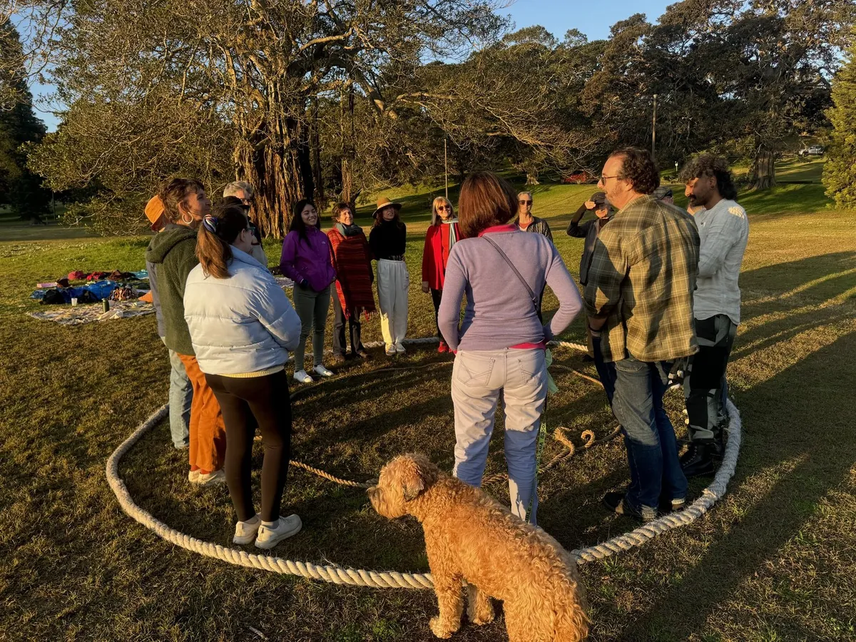 Regen Sydney community gathering in a rope circle at sunset